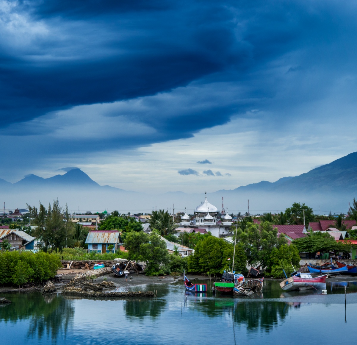 Photo of early morning in Banda Aceh. Big clouds and misty mountains.