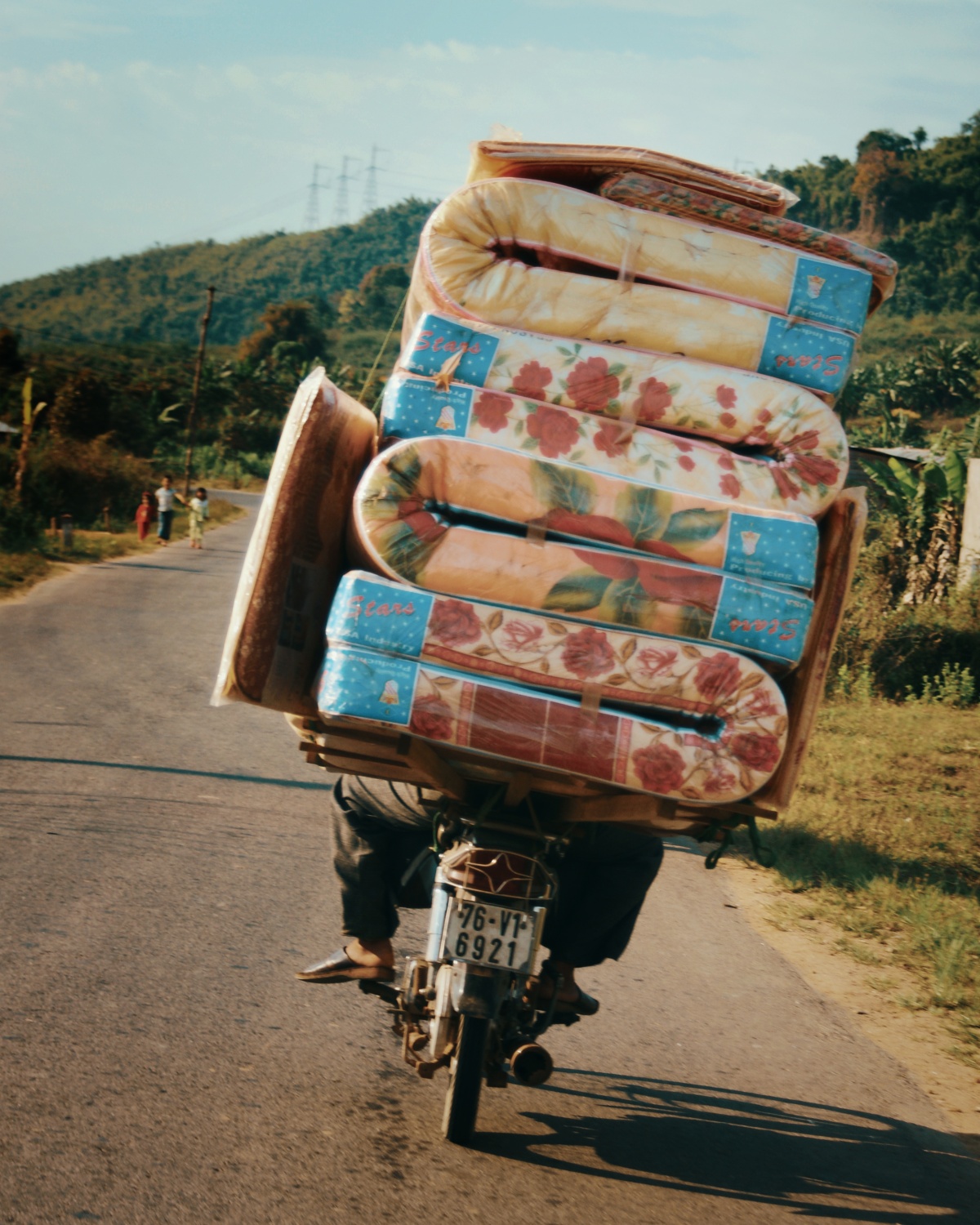 Photo of motorbike guy delivering mattresses and almost falling over