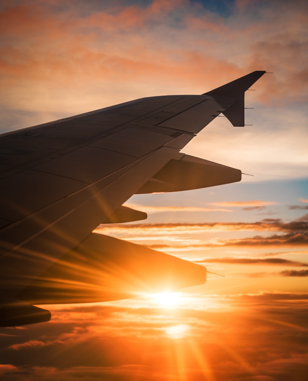 Photo of jetplane wing and sunset