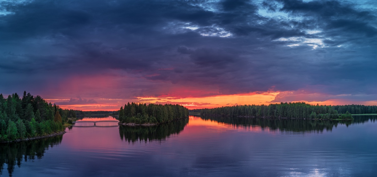 Panorama photo of sunset over river Oulujoki, Vaala, Finland