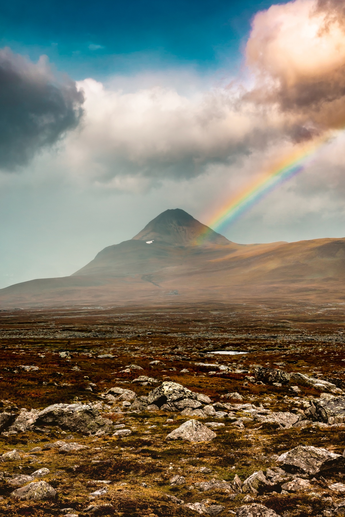 Photo of colorful rainbow over Barras Mountain in Northern Sweden