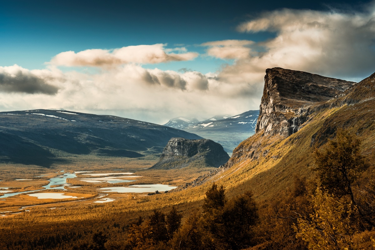 Autumn colors and beautiful landscape over Sarek river valley and Skierfe cliff