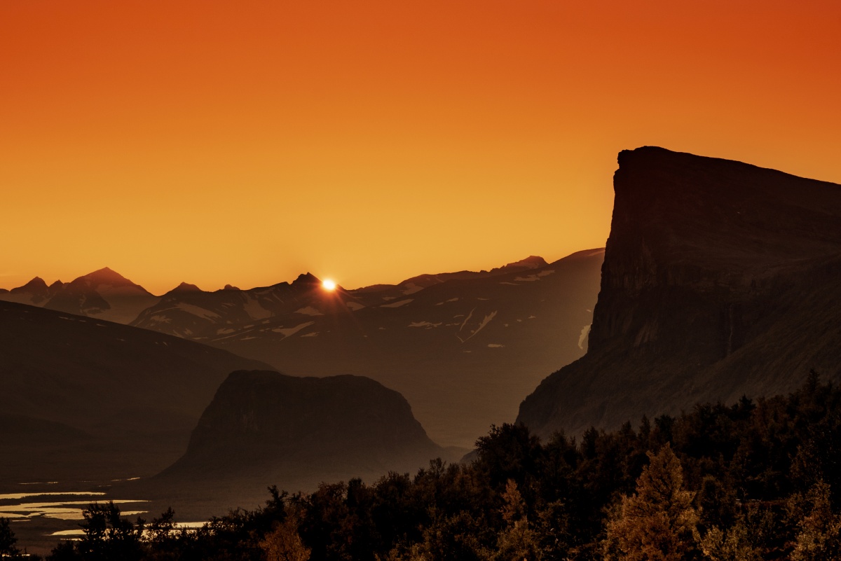 Photo of amazing sunset over river valley and Skierfe cliff