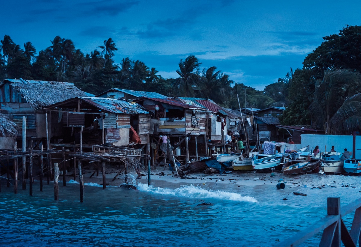 Photo of poor looking fishing village on tropical Mabul island. The photo was taken at night.